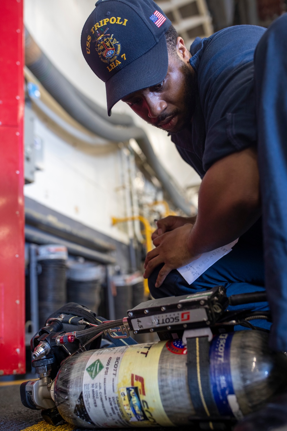 USS Tripoli Sailors Preform Maintenance
