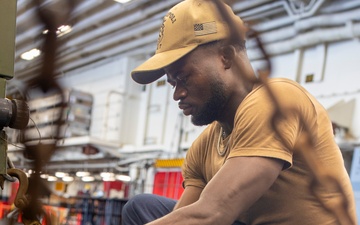 USS Tripoli Sailors Preform Maintenance