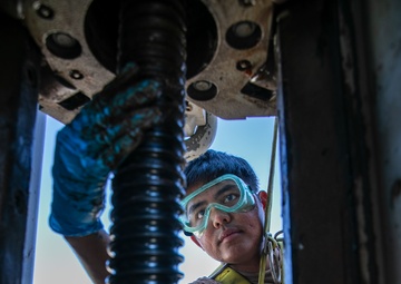 USS Mitscher (DDG 57) Sailor conducts sliding padeye maintenance