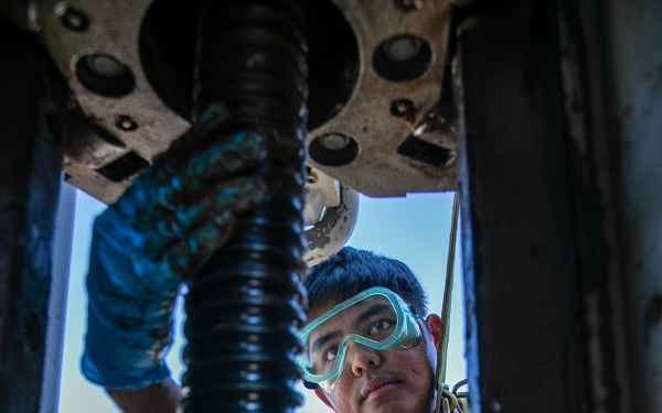 USS Mitscher (DDG 57) Sailor conducts sliding padeye maintenance