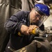 USS Mitscher (DDG 57) Sailor conducts machine shop maintenance