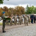 Polish Soldier holds wreath at monument