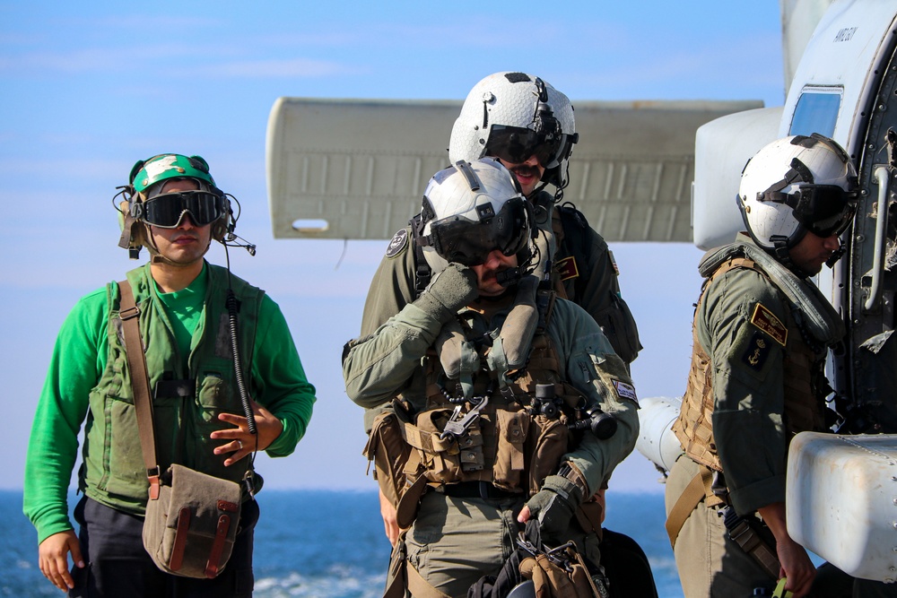 Sailors prepare for the departure of MH-60R Seahawk during the Northern Coasts 2025
