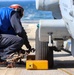 BM3 Carlens Milice removes the chocks and chains prior to an MH-60R Seahawk take-off during the Northern Coasts 2025