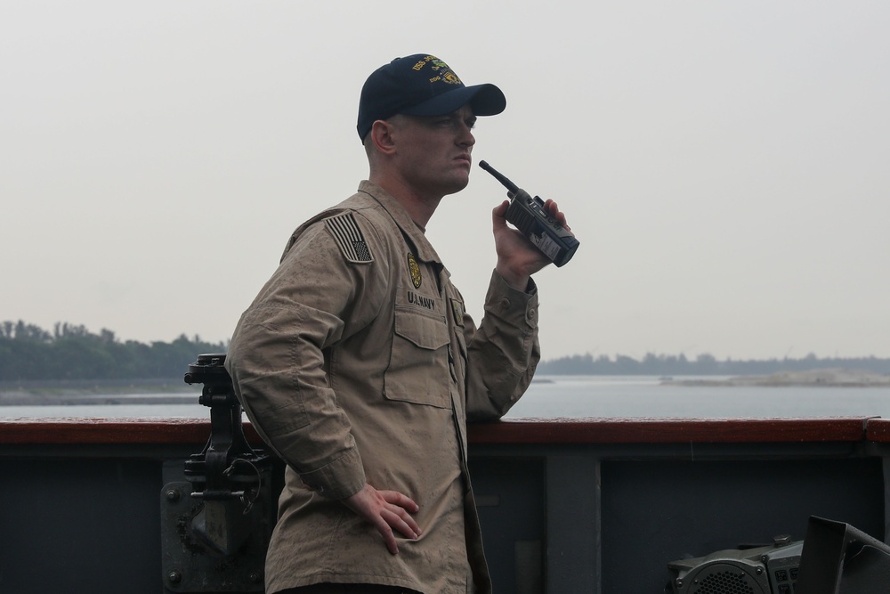 Sailors aboard the USS John Finn conduct a sea and anchor detail in Changi, Singapore