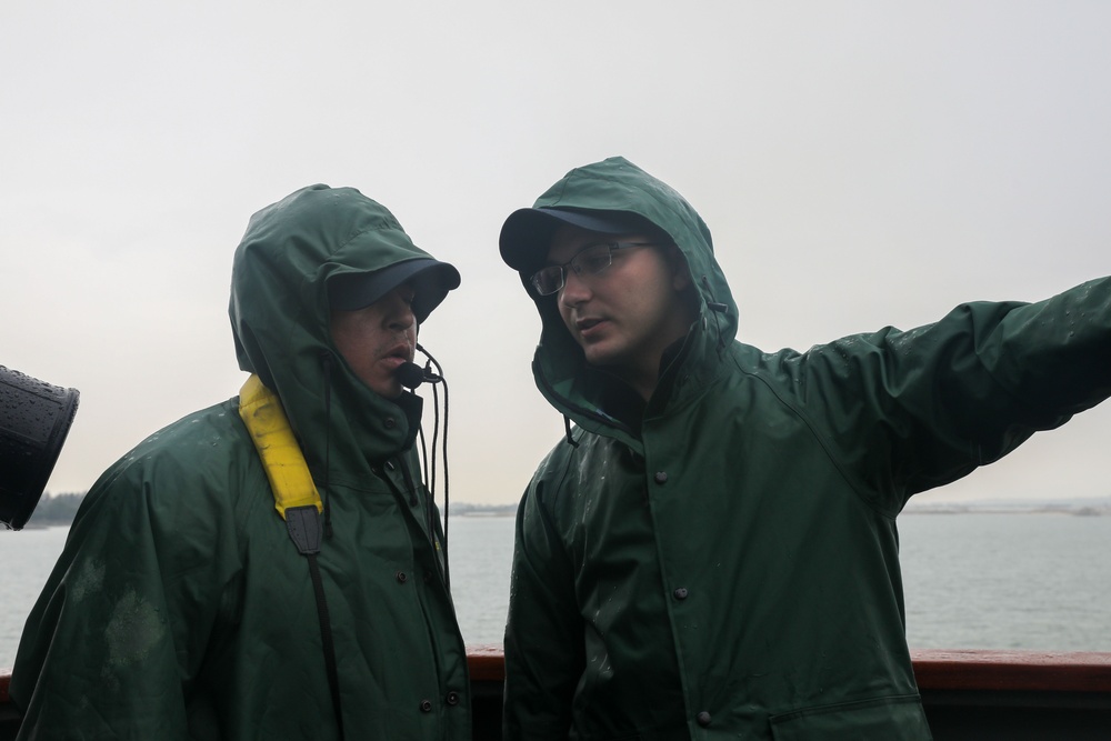Sailors aboard the USS John Finn conduct a sea and anchor detail in Changi, Singapore