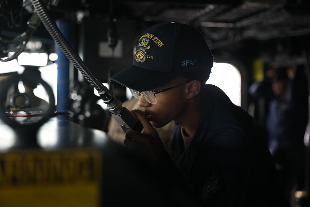 Sailors aboard the USS John Finn conduct a sea and anchor detail in Changi, Singapore