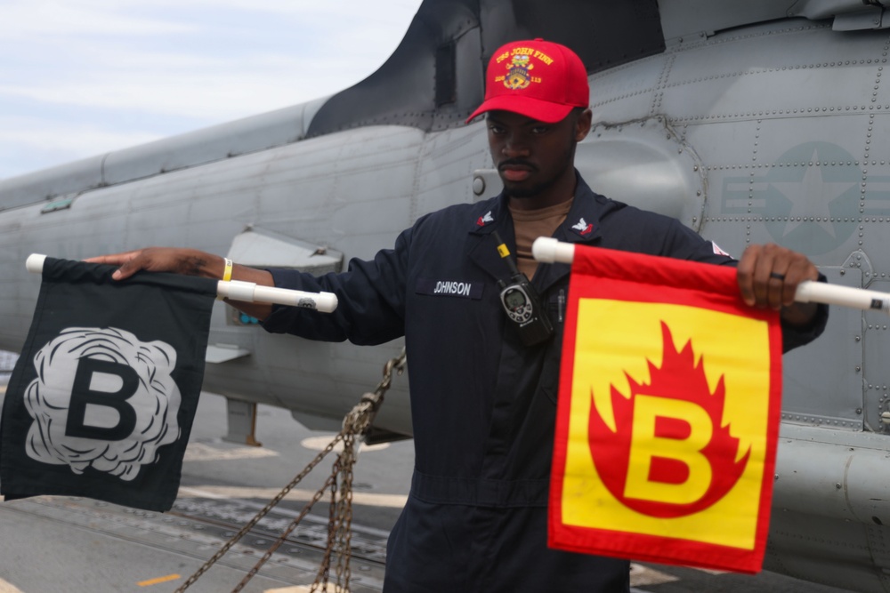 Sailors aboard the USS John Finn conduct flight quarters in the South China Sea