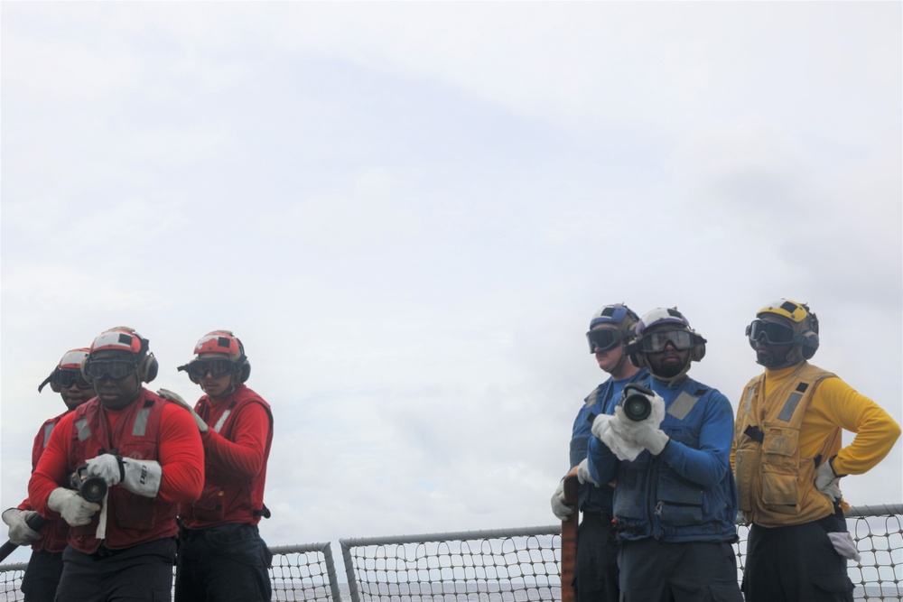 Sailors aboard the USS John Finn conduct flight quarters in the South China Sea