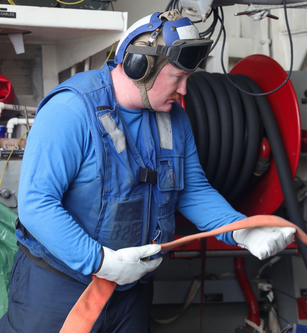 Sailors aboard the USS John Finn conduct flight quarters in the South China Sea