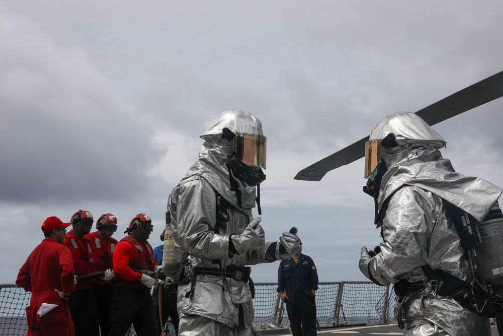 Sailors aboard the USS John Finn conduct flight quarters in the South China Sea
