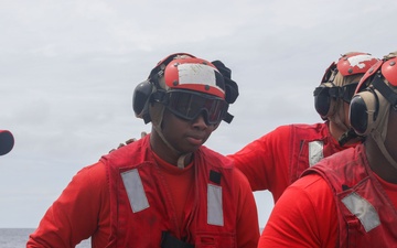 Sailors aboard the USS John Finn conduct flight quarters in the South China Sea