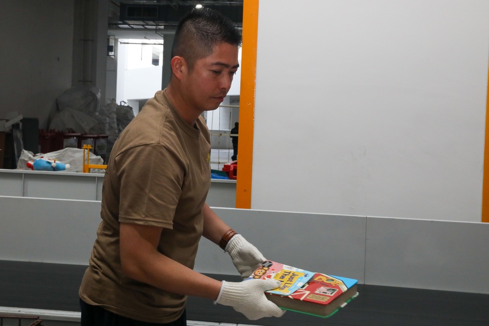 Sailors attached to the USS John Finn volunteer at the Salvation Army in Singapore