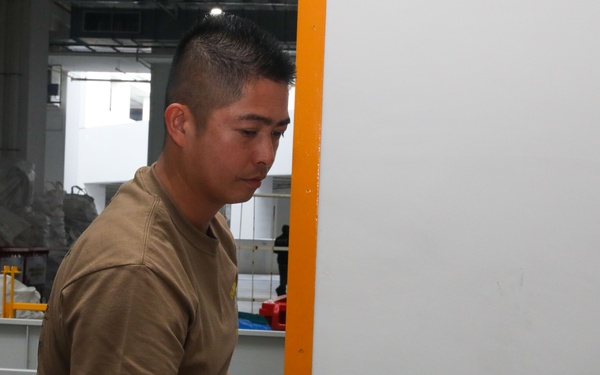 Sailors attached to the USS John Finn volunteer at the Salvation Army in Singapore