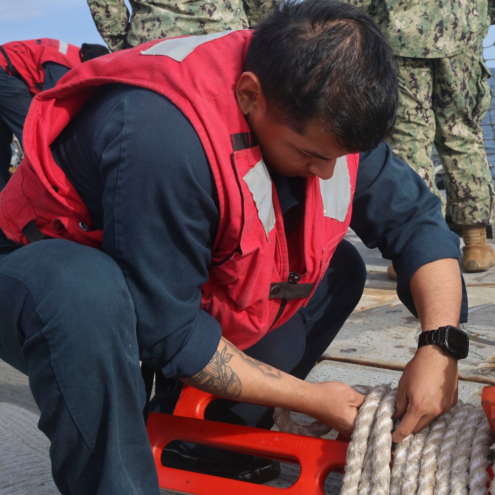 SR Freddy Climaco unfastens the pilot ladder to receive a small boat personnel transfer during NoCo25