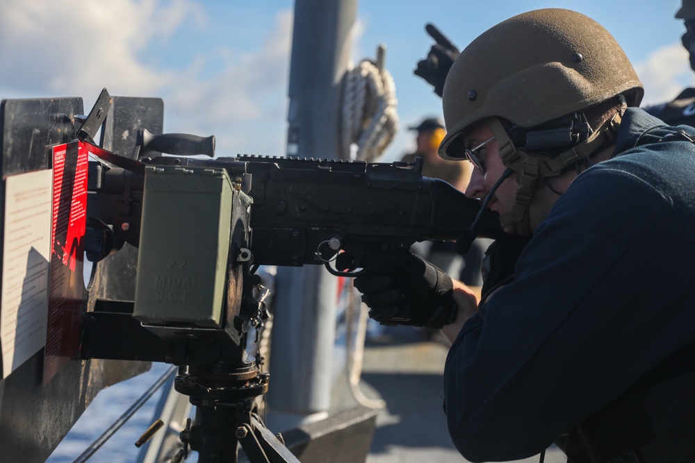 Sailors aboard the USS John Finn conduct an M240 gunshoot in the South China Sea