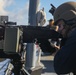Sailors aboard the USS John Finn conduct an M240 gunshoot in the South China Sea