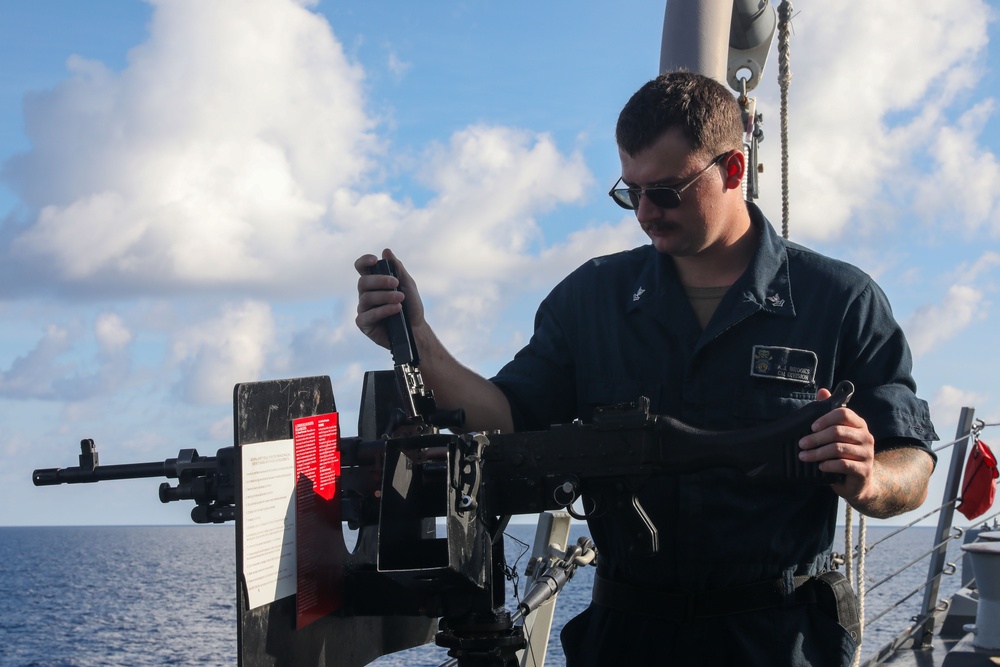 Sailors aboard the USS John Finn conduct an M240 gunshoot in the South China Sea