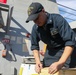 Sailors aboard the USS John Finn conduct an M240 gunshoot in the South China Sea