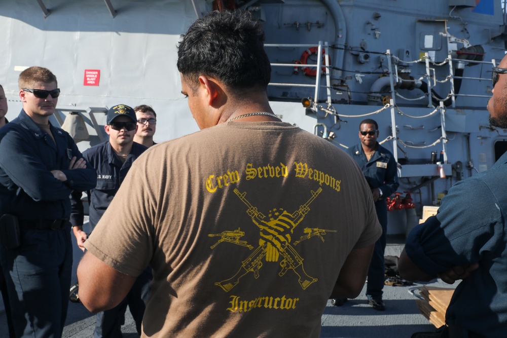 Sailors aboard the USS John Finn conduct an M240 gunshoot in the South China Sea
