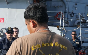 Sailors aboard the USS John Finn conduct an M240 gunshoot in the South China Sea