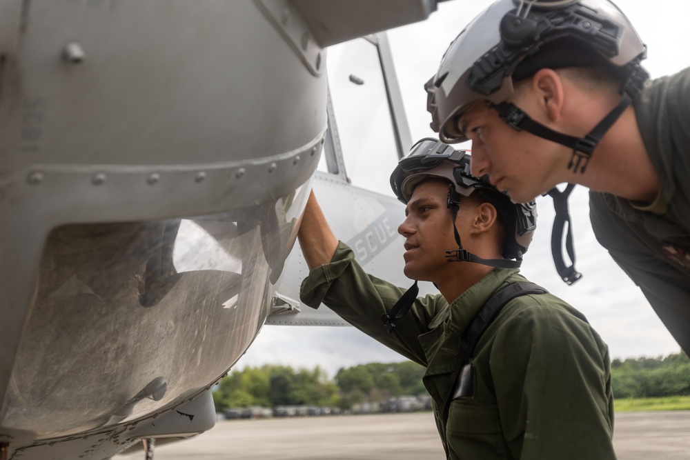 U.S. Marines with 1st Marine Aircraft Wing maintain helicopters