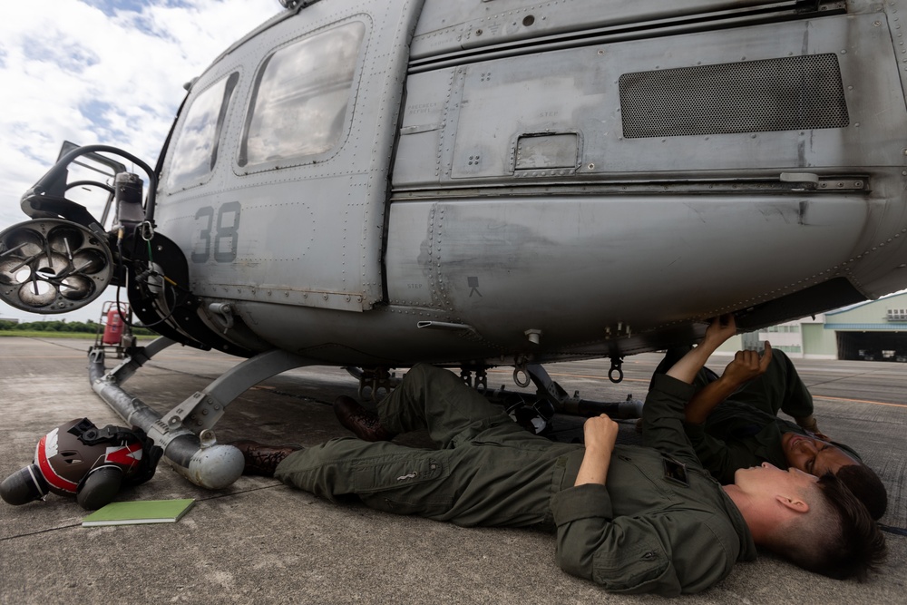 U.S. Marines with 1st Marine Aircraft Wing maintain helicopters