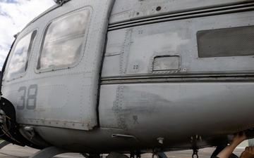 U.S. Marines with 1st Marine Aircraft Wing maintain helicopters