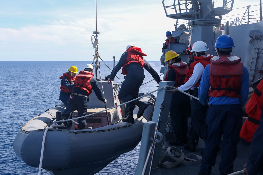 Sailors aboard the USS John Finn conduct a small boat operation during Maritime Cooperative Act in the South China Sea