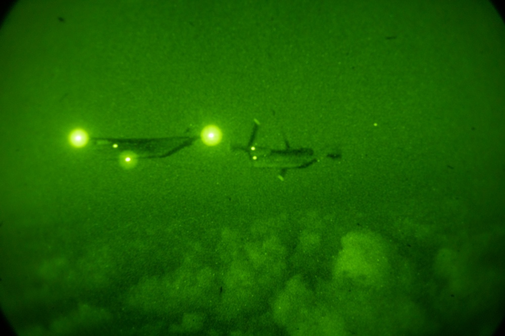 U.S. Marine MV-22B Ospreys refuel at night off the coast of Kagoshima, Japan