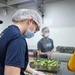 USS Frank Cable (AS 40) Sailors assemble lunches at Singapore soup kitchen