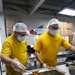 USS Frank Cable (AS 40) Sailors assemble lunches at Singapore soup kitchen