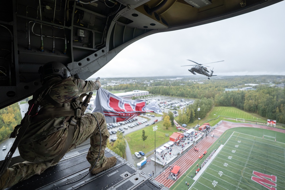 Alaska Army National Guard helicopter aviators conduct flyover for Wasilla High School football game