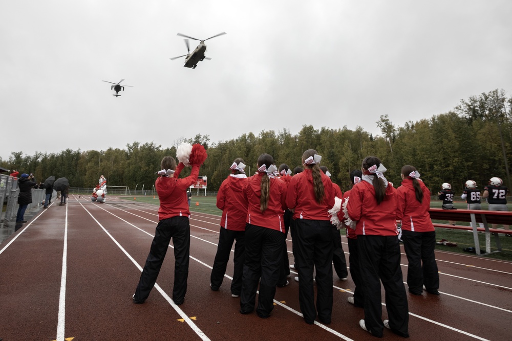 Alaska Army National Guard helicopter aviators conduct flyover for Wasilla High School football game