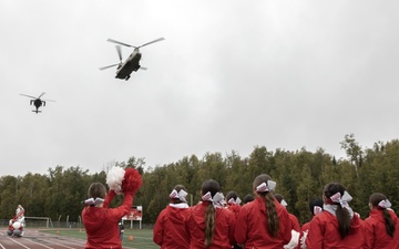 Alaska Army National Guard helicopter aviators conduct flyover for Wasilla High School football game