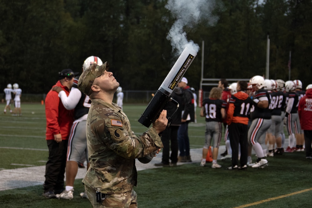 Alaska Army National Guard helicopter aviators conduct flyover for Wasilla High School football game
