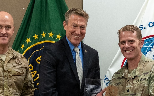 Customs and Border Protection Commissioner Rodney Scott presents a placard of appreciation to Lieutenant Colonel Matthew S. Bauer, commander of Fort A.P. Hill