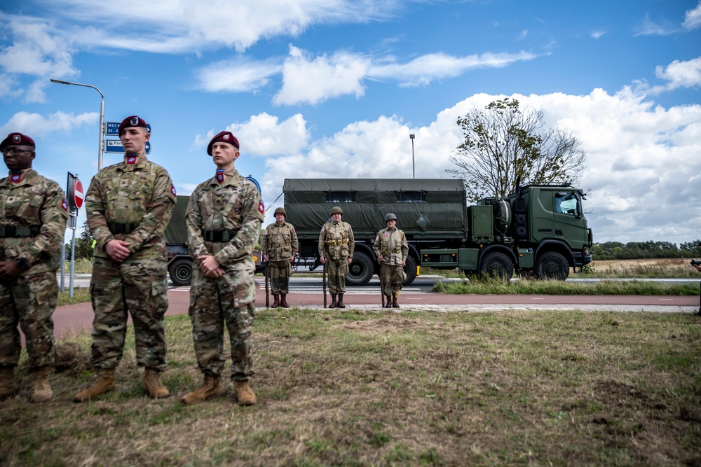 Here’s the caption smoothly revised to include the WWII 82nd reenactment team: