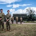 Here’s the caption smoothly revised to include the WWII 82nd reenactment team: