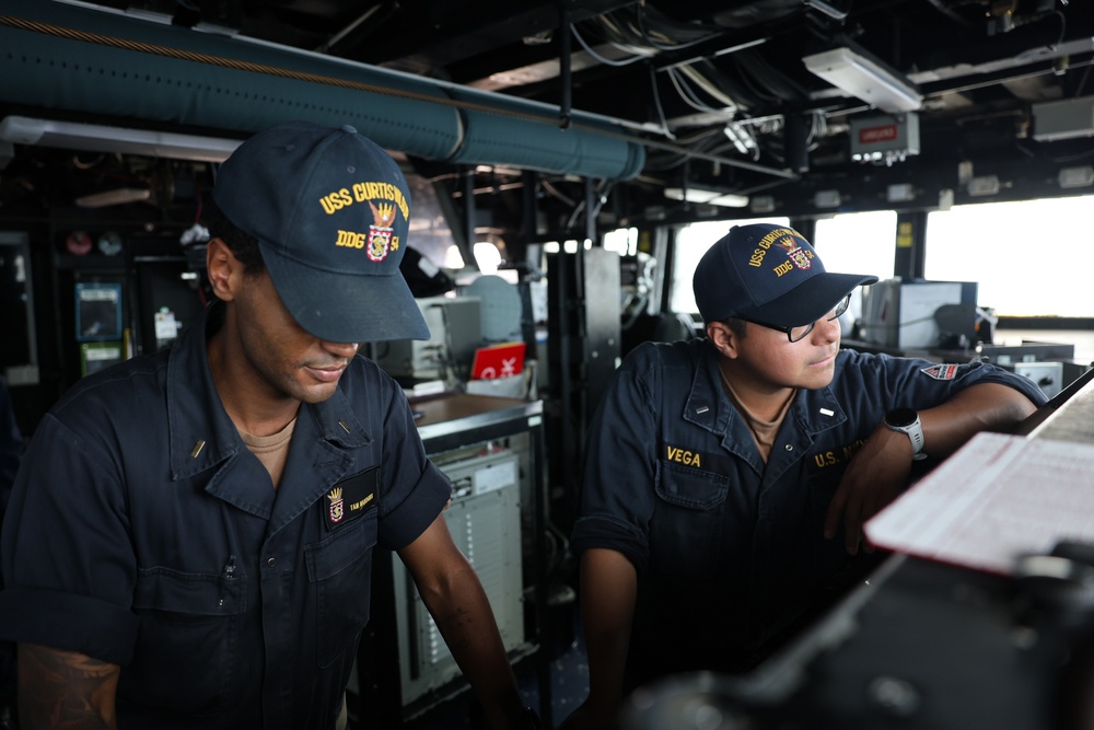 USS Curtis Wilbur (DDG 54) Sailors Man The Bridge