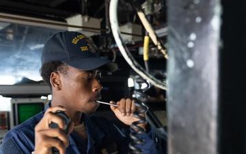 USS Curtis Wilbur (DDG 54) Sailor Conducts Boatswain's Pipe Call
