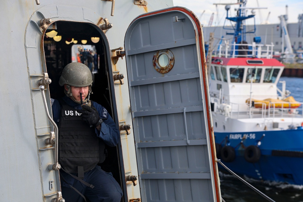 GM3 Barbaro Olivera uses a handheld radio during a sea-and-anchor evolution