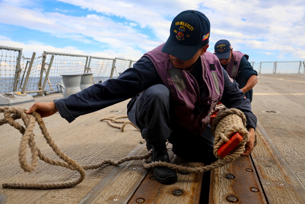 STG3 Abalos Axlross and STGSN Nathan Antepara stow the pilot ladder during sea-and-anchor