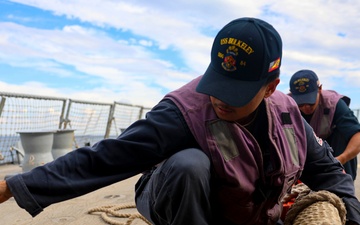 STG3 Abalos Axlross and STGSN Nathan Antepara stow the pilot ladder during sea-and-anchor