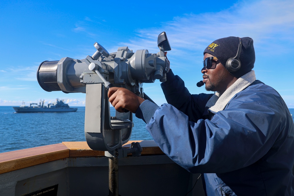 BMSN William Mwiseneza  uses the ship mounted binoculars during the Northern Coasts 2025