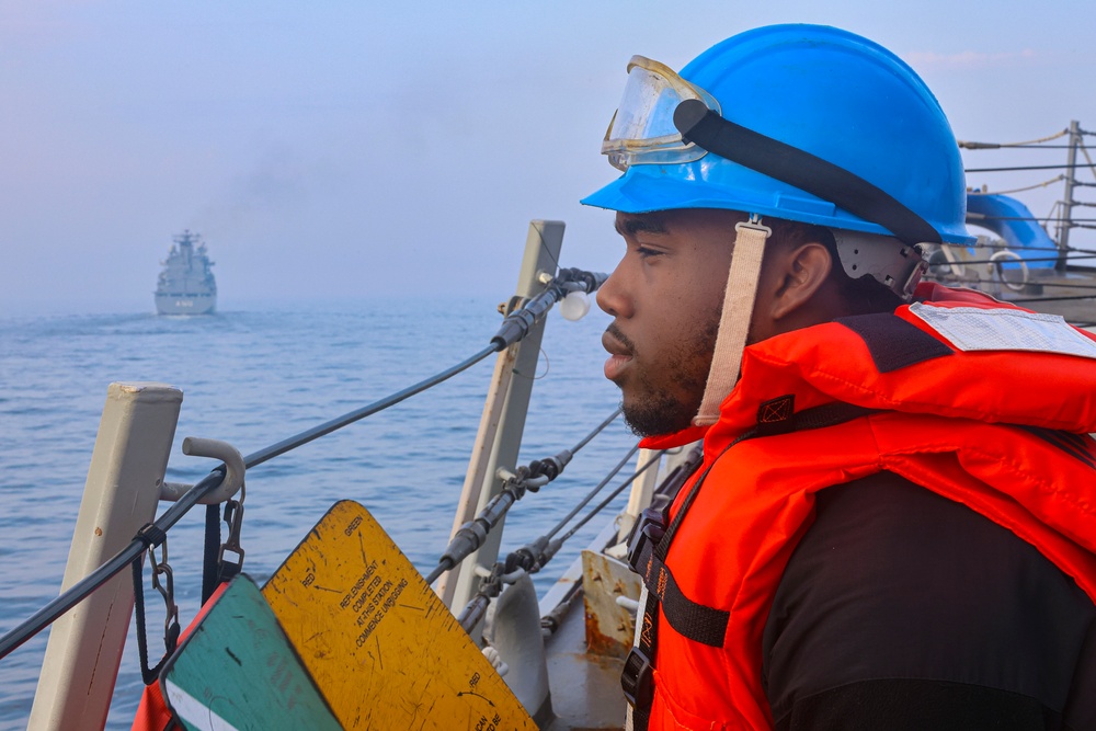 SN Connor Bailey takes his statio on the foc’sle for a replenishment-at-sea  during exercise Northern Coasts 2025