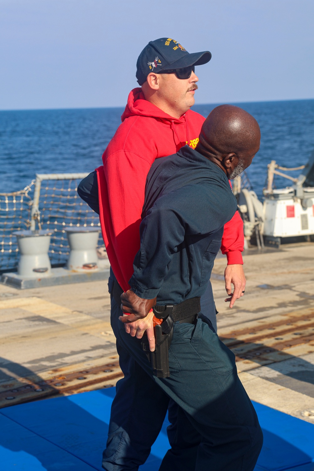 MA1 Corey Pilcher and GM1 Don Dume demonstrate non-lethal weapons training and gun grab defense during exercise Northern Coasts 2025