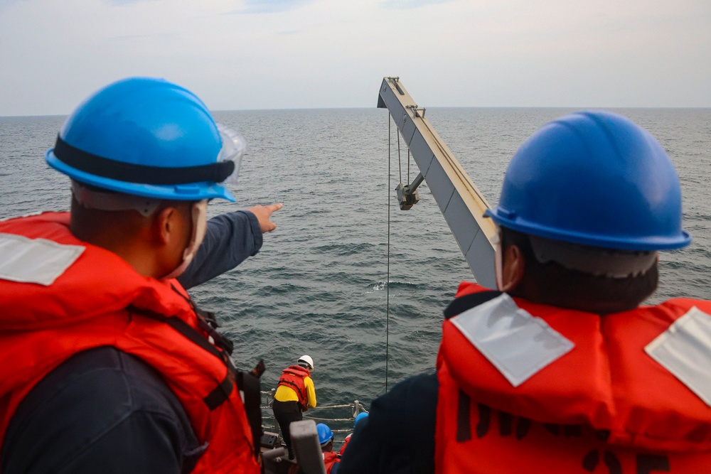 USS Bulkeley (DDG 84) Sailors  launch the rigid-hulled inflatable boat for small boat operations during exercise Northern Coasts 2025