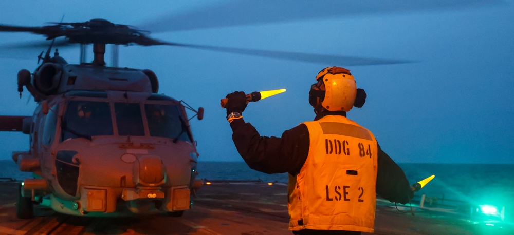 BM1 Jason Carpenter signals to pilots during exercise Northern Coasts 2025