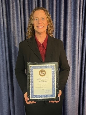 Pam Kochis receives the Excellence in the Pursuit of Justice award